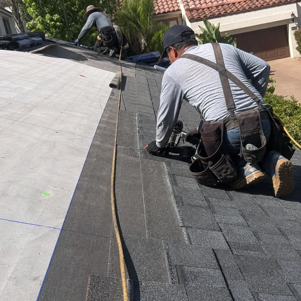 Professional roofer installing flashing on a residential shingle roof